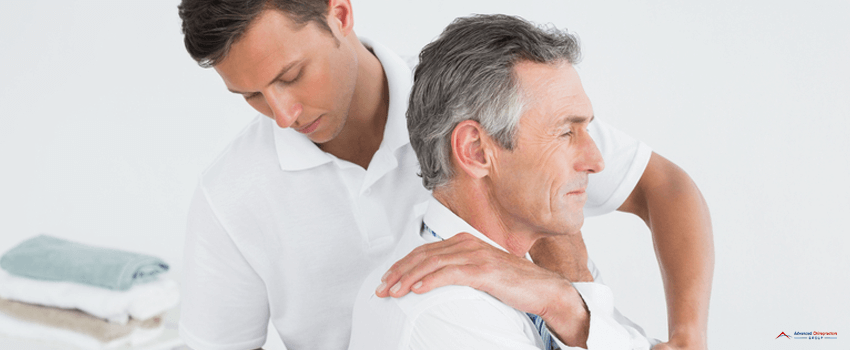 ACG-Male chiropractor examining mature man