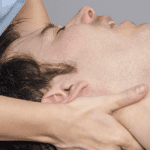 ACG-physiotherapist, chiropractor doing intraoral technique of massage masseter muscle