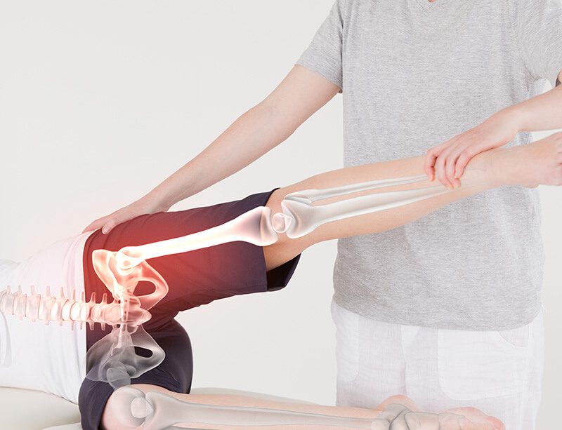 ACG Digital composite of Highlighted bones of woman at physiotherapist