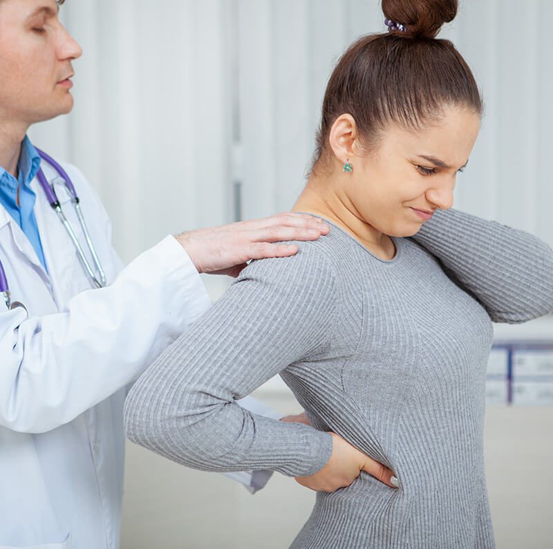 ACG - Young woman suffering from back pain